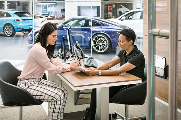 Customer service in a Porsche dealership.